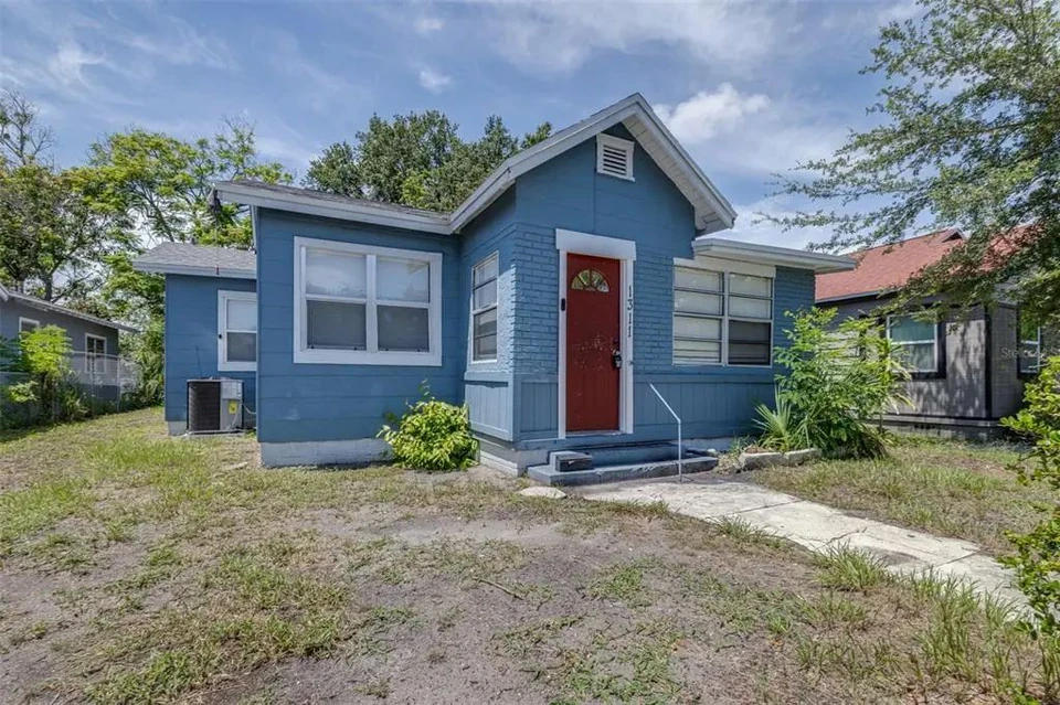 Front exterior with red entry door at 1311 Prescott Street S