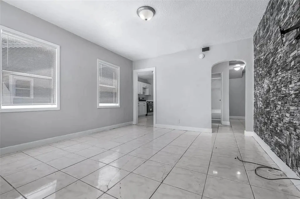 Living area with tile flooring and accent wall at 1311 Prescott Street S