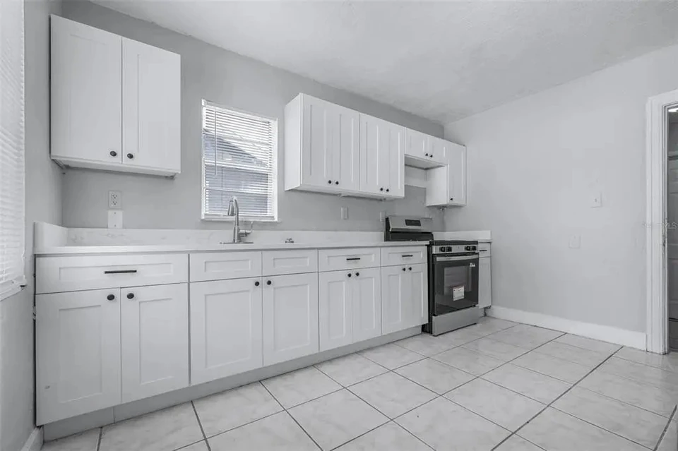 Kitchen with white cabinetry and range at 1311 Prescott Street S