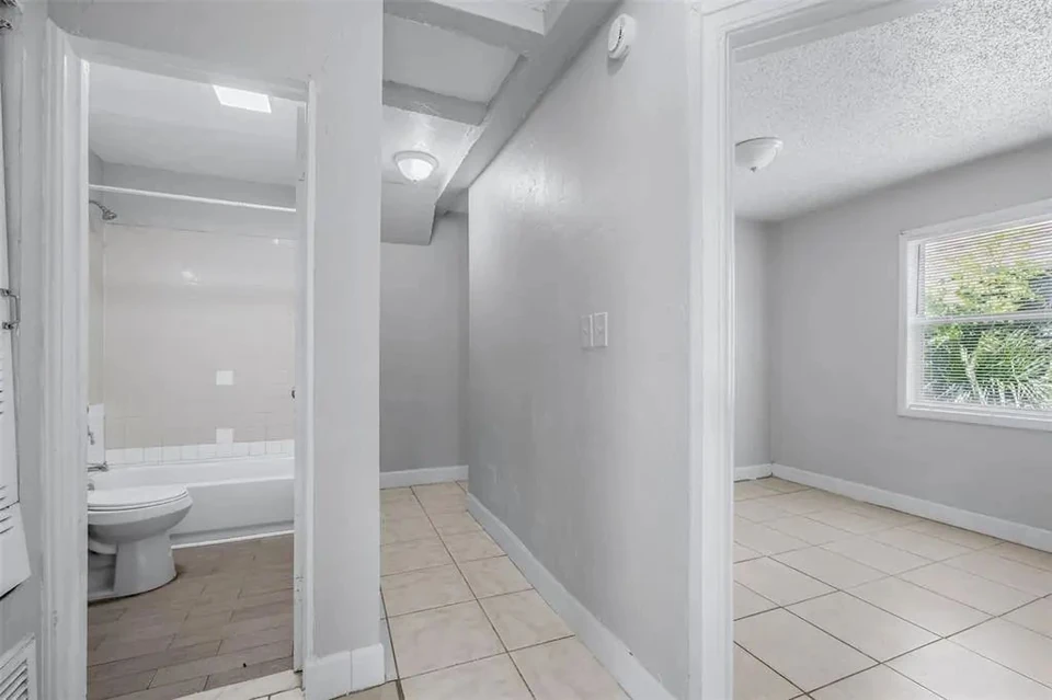 Interior room and adjoining bathroom doorway at 1311 Prescott Street S