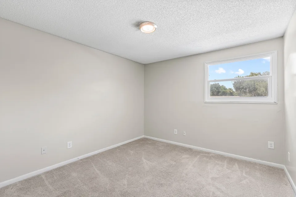 Secondary bedroom with window and closet
