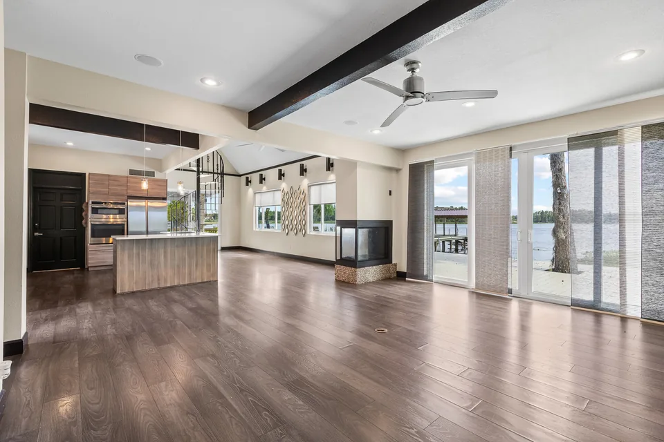 Great room with tall windows overlooking Lake Keene