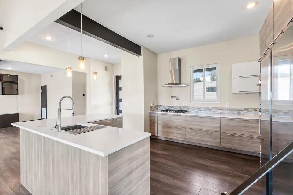 Renovated kitchen with island seating and dark wood cabinetry