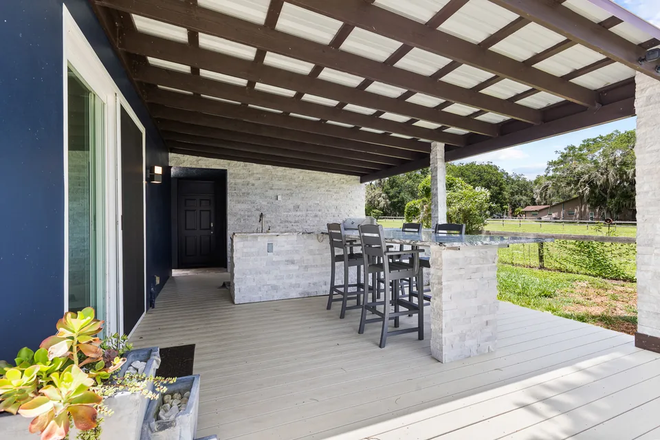 Covered outdoor kitchen beside the pool area