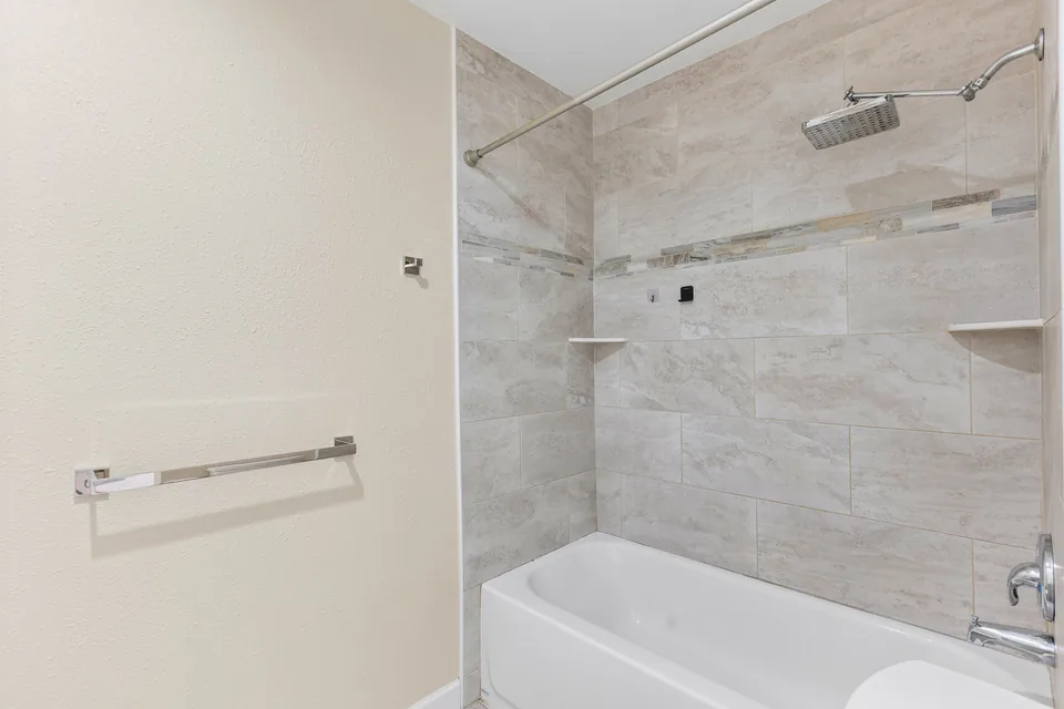 Primary bathroom shower and tub area