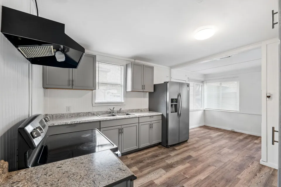 Kitchen with gray cabinets and stainless appliances