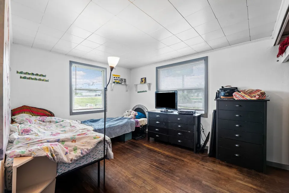 Occupied bedroom with two windows