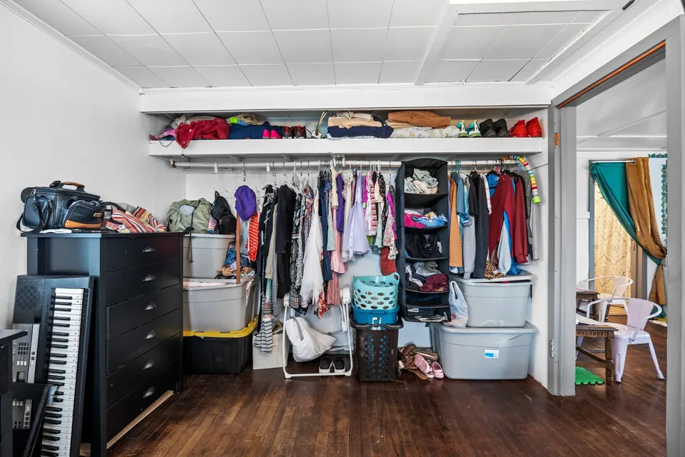 Open clothes-storage area in occupied bedroom