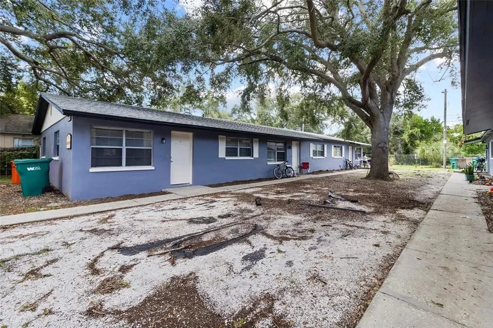 Exterior of the triplex with paved parking area at 3735 141st Place