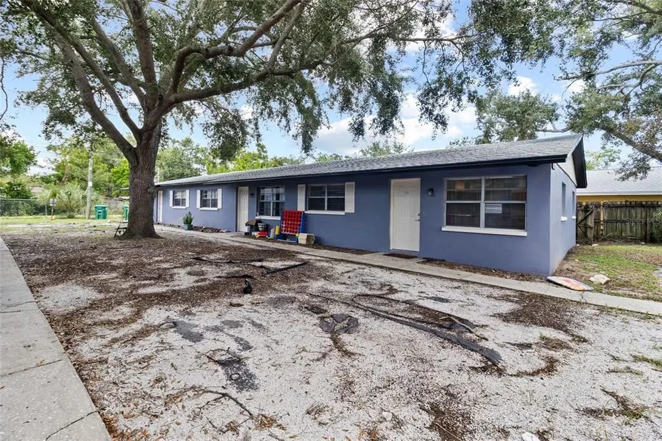 Front exterior and paved parking area of the triplex at 3753 141st Place