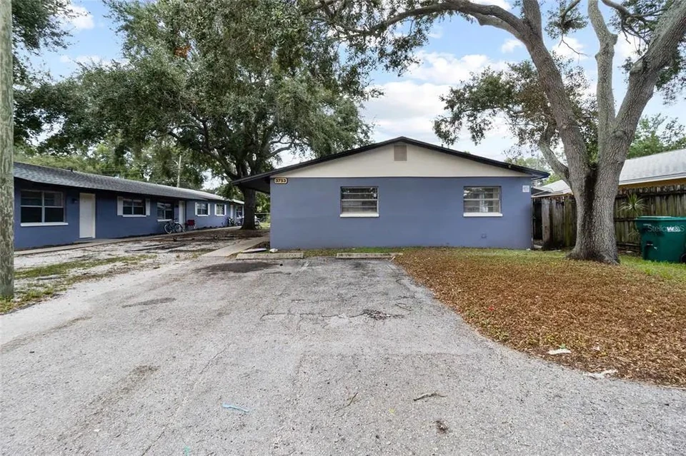 Triplex exterior beside a mature tree at 3753 141st Place