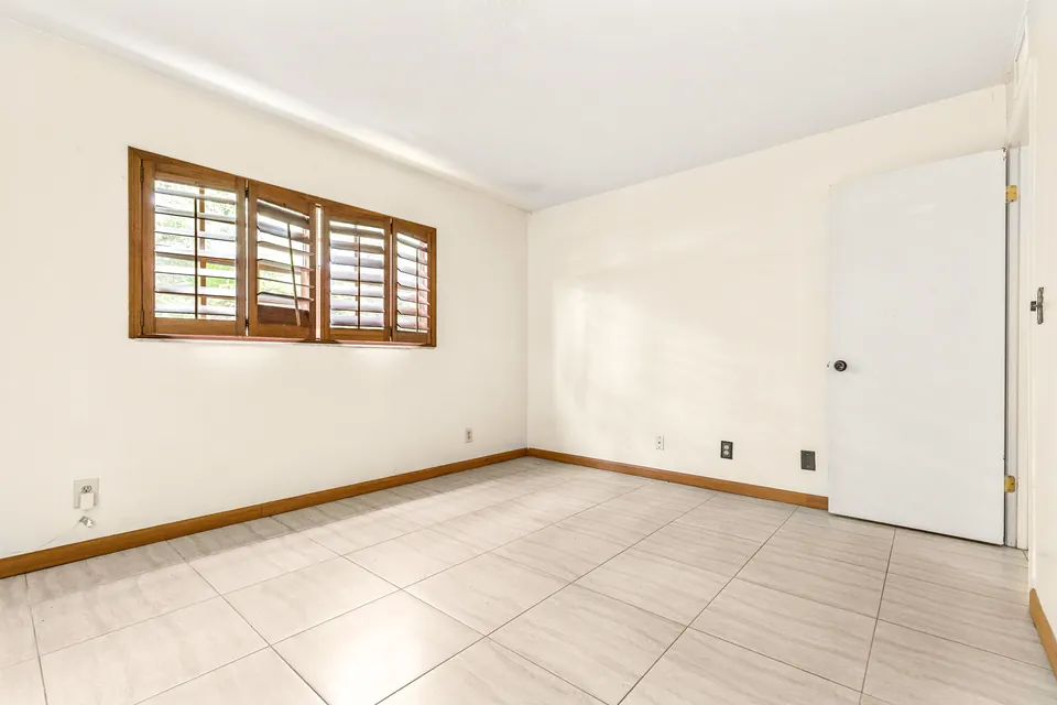 Bedroom with tiled floor and window