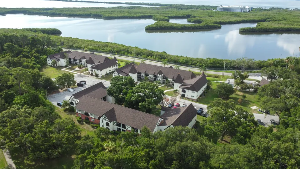 Aerial view of condominium buildings and waterfront surroundings