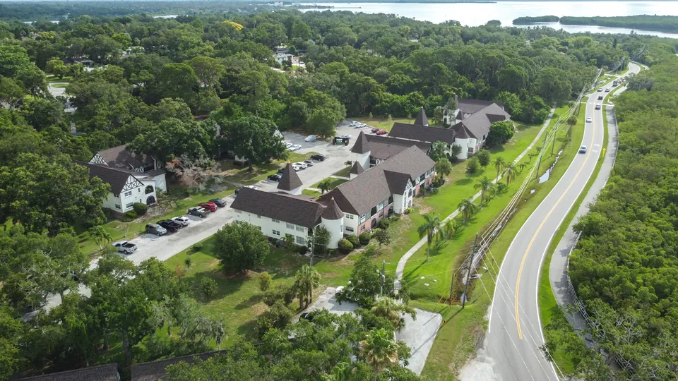 Aerial view of the community, roadway, and bay