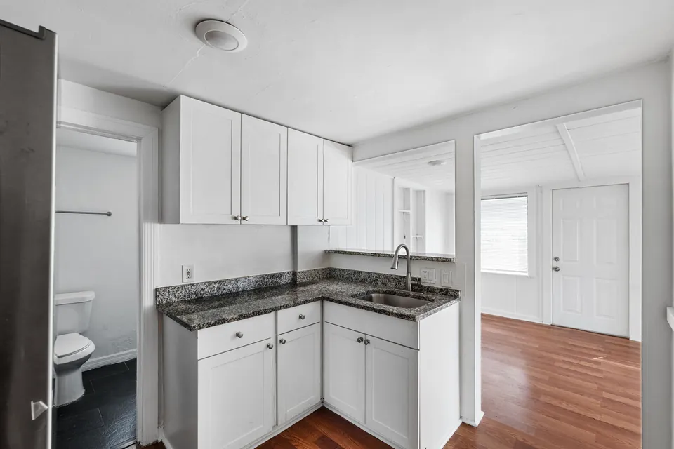 Kitchen with white cabinets and granite-look counters