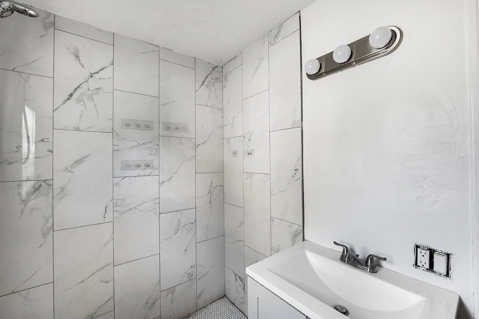 Bathroom vanity and mirrored wall