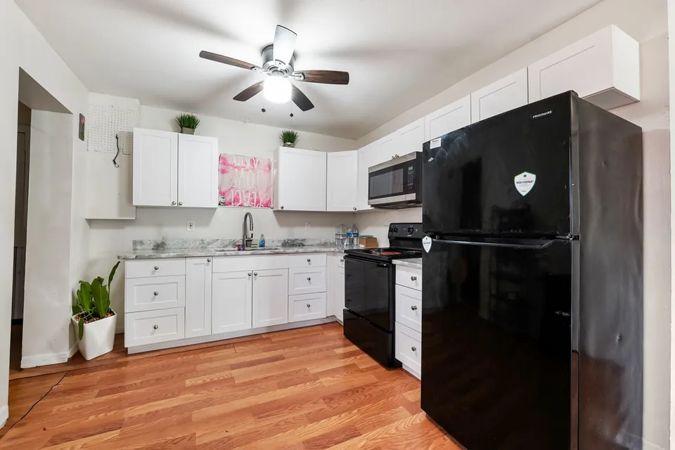 Rear-residence kitchen with white cabinets