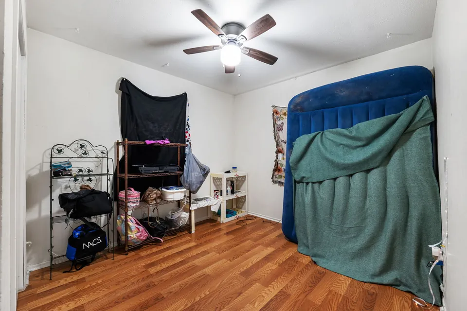 Occupied bedroom with ceiling fan