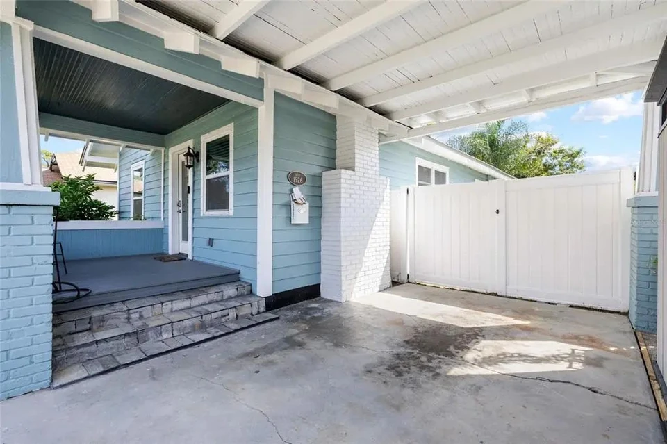 Covered carport beside the front porch at 5907 N Ola Avenue