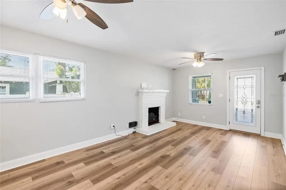 Living room with windows and fireplace at 5907 N Ola Avenue