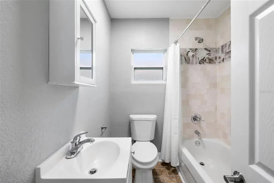 Bathroom with tiled tub surround at 5907 N Ola Avenue