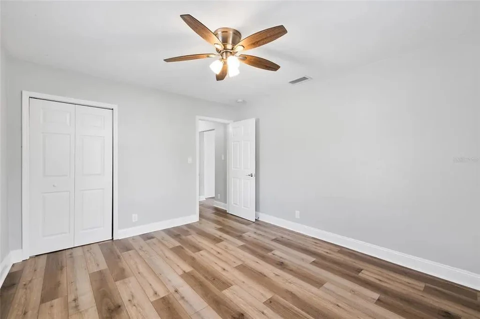 Bedroom with ceiling fan and closet at 5907 N Ola Avenue