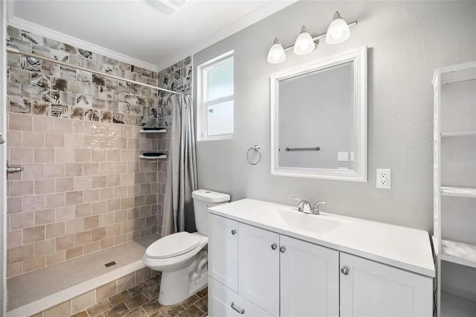 Bathroom vanity and walk-in shower at 5907 N Ola Avenue
