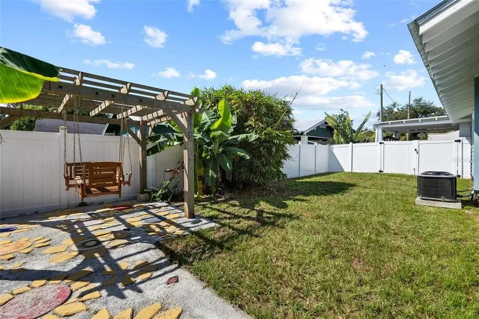Fenced backyard and covered seating area at 5907 N Ola Avenue