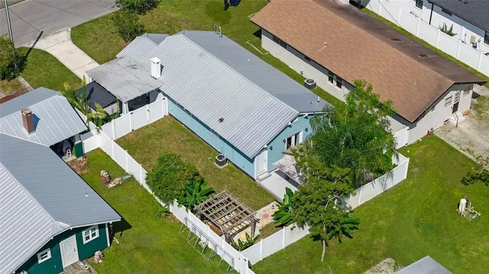 Aerial view of the home and fenced backyard at 5907 N Ola Avenue