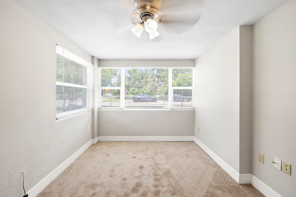 Bright front room with wraparound windows