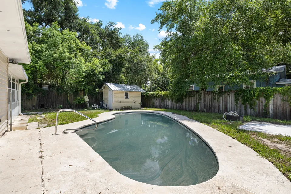 Pool and rear yard from the opposite side