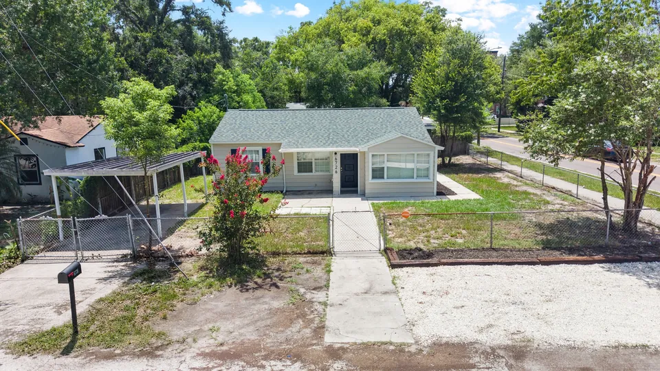Overhead view of the home, carport, and pool