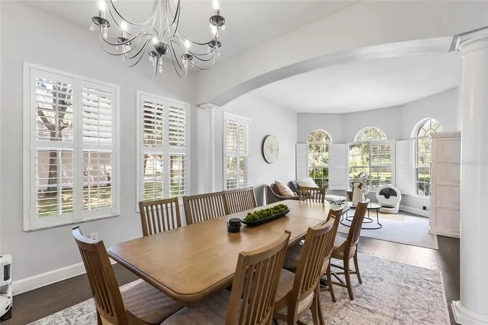 Dining room with windows and chandelier at 9113 Creedmoor Lane