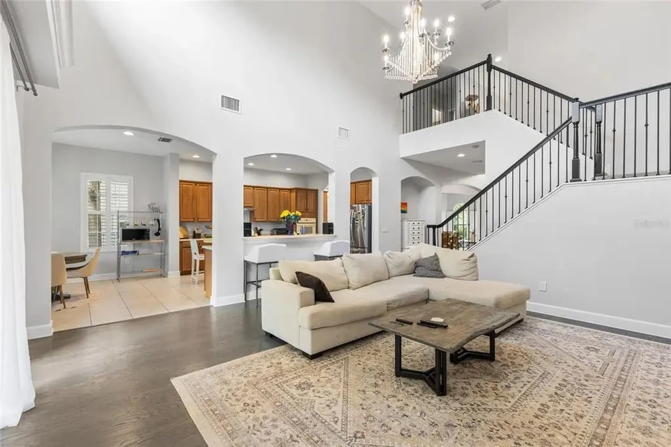 Family room with high ceilings and staircase at 9113 Creedmoor Lane