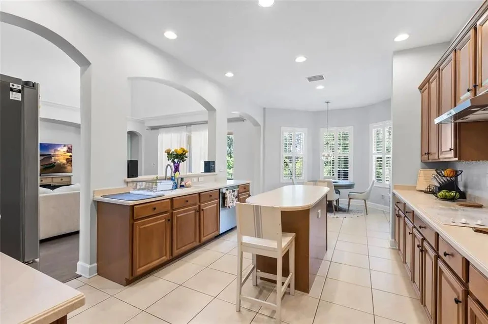 Kitchen with island and wood cabinetry at 9113 Creedmoor Lane