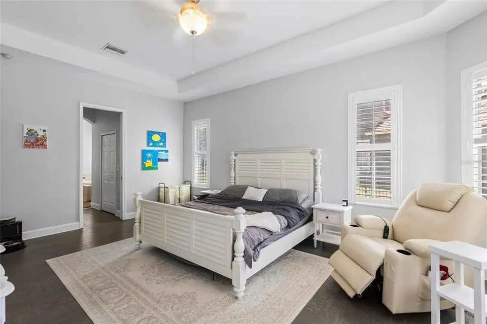 Primary bedroom with seating area at 9113 Creedmoor Lane